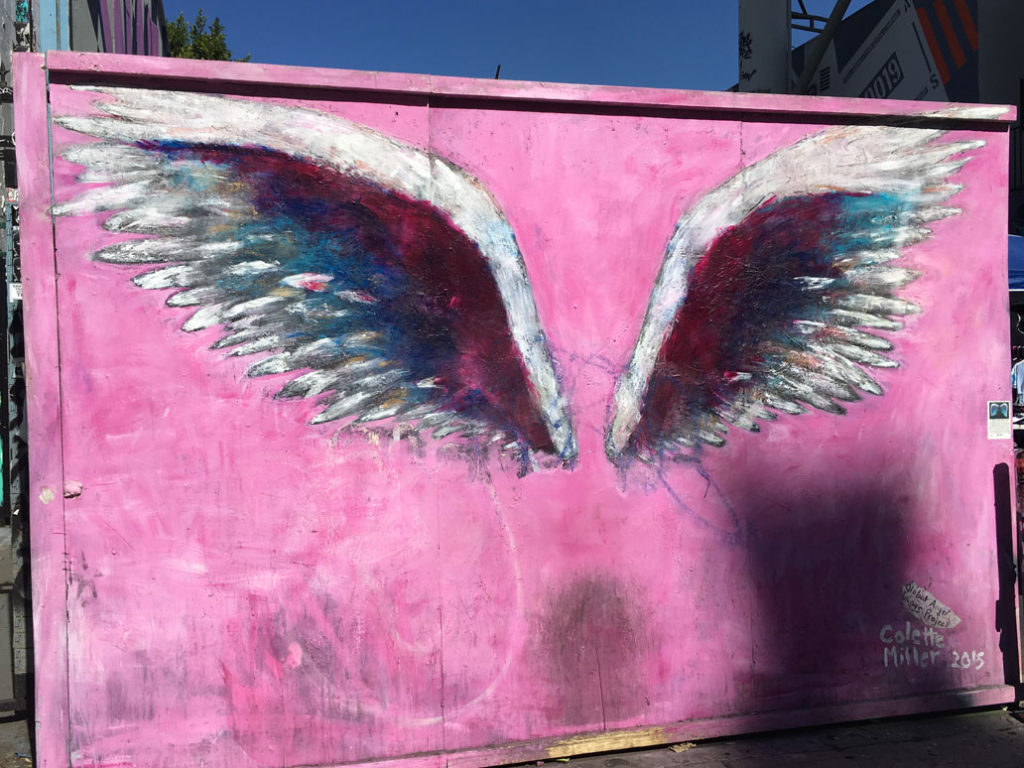 Colette Miller's iconic pink Angel Wings mural in Mural Alley